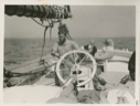 Image of On Board the Thebaud, Russell Welsh at wheel
